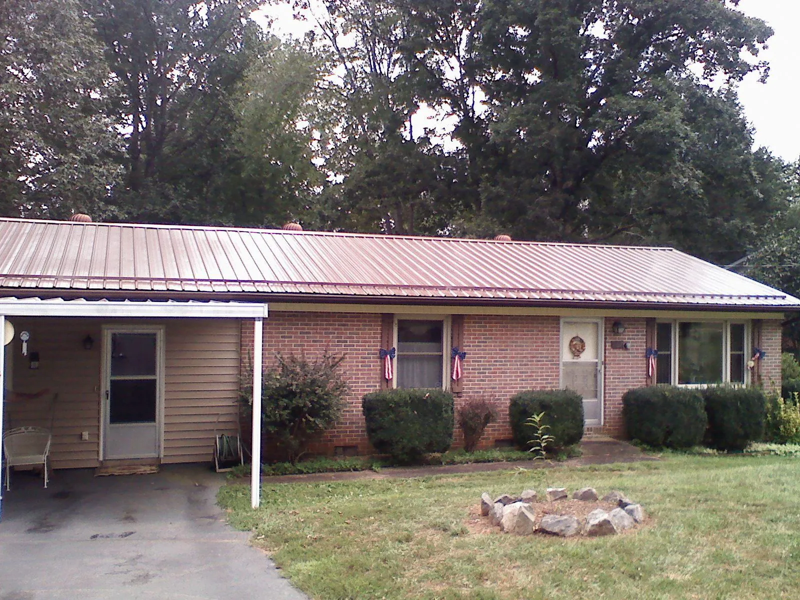 Bronze metal roof and carport on a brick ranch home — Roof Repair work by our crew in Oak Lawn