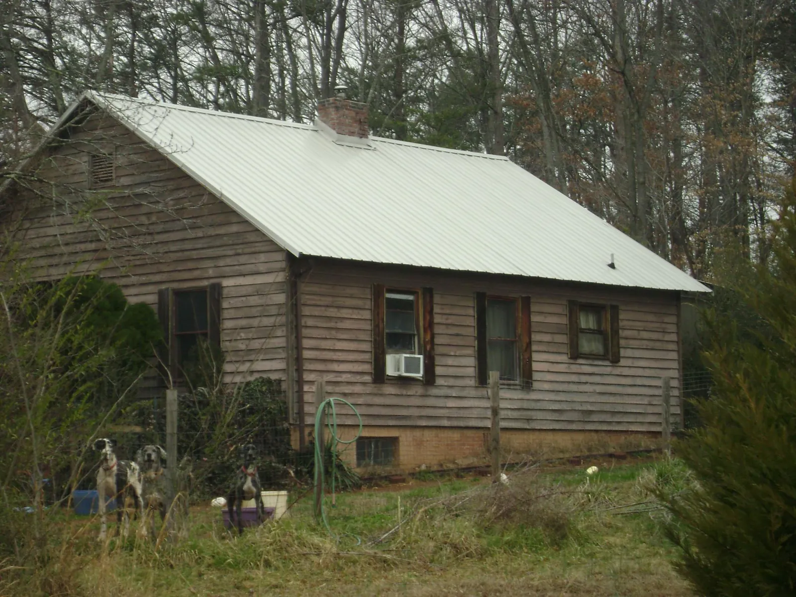 White metal roof on an old wood sided farmhouse, from a Metal Roof Installation job in Oak Lawn